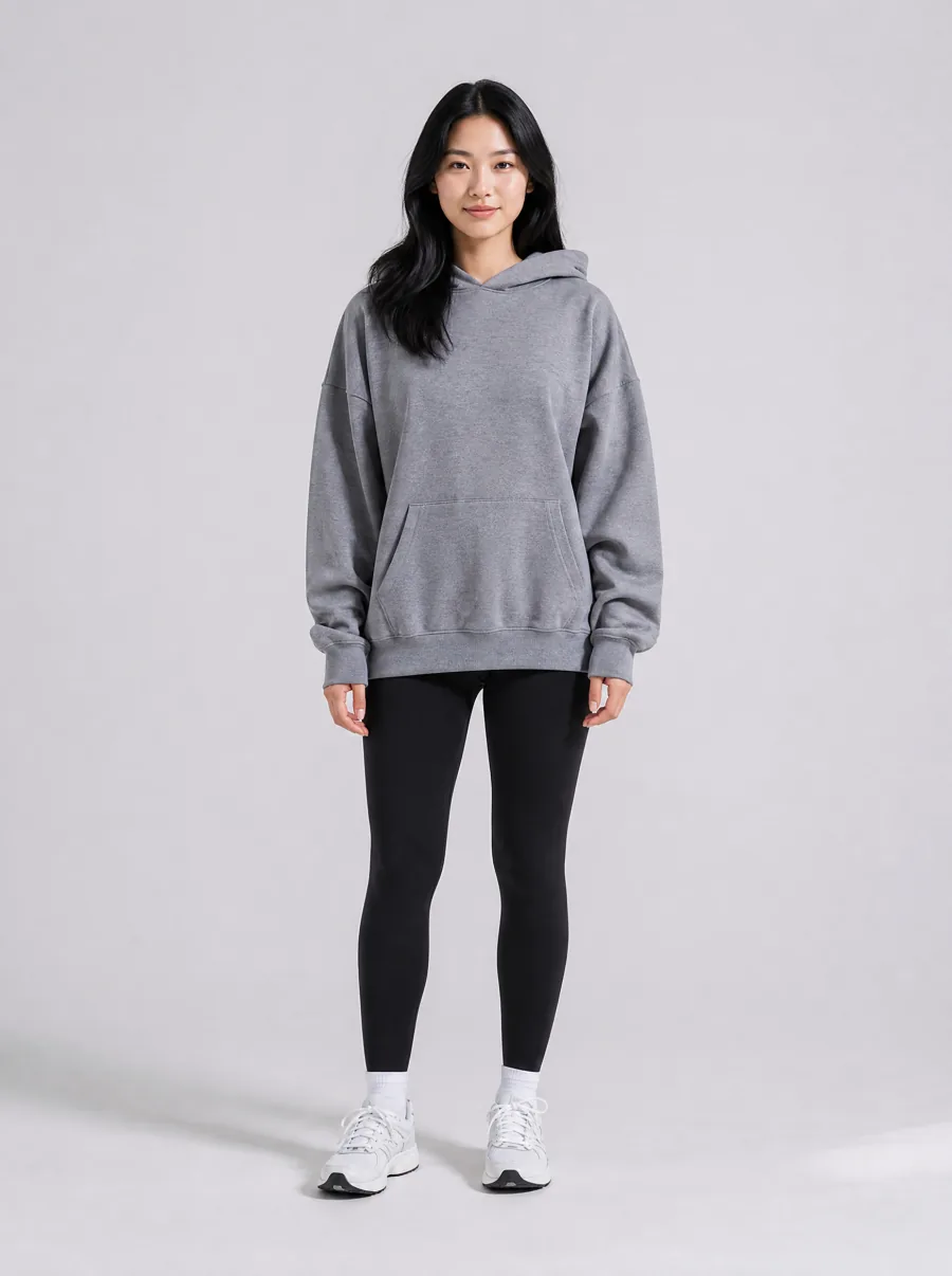 AI try-on before: woman in an oversized grey hoodie and black athletic leggings