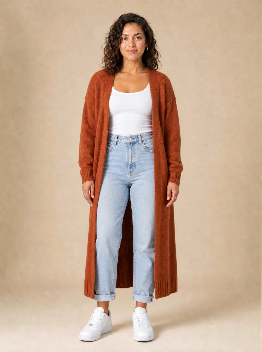 AI try-on after: same woman virtually styled by TryBit in a white ribbed tank, rust-orange longline cardigan, and light blue straight jeans